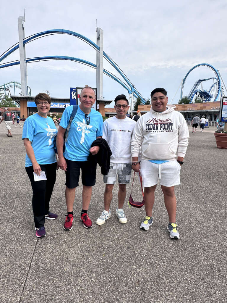 Teens and Adults in front of a rollercoaster at Cedar Point