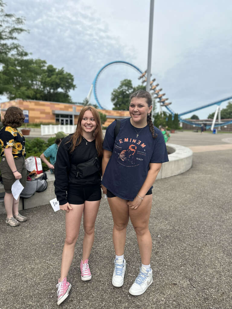 Two teens in front of a rollercoaster at Cedar Point